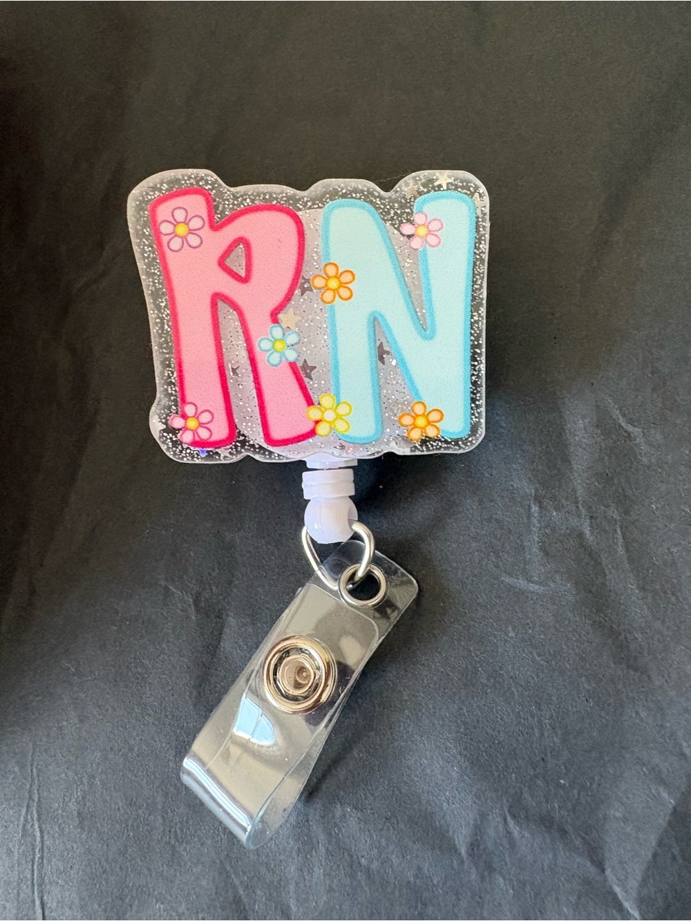 RN Glitter Badge Reel with Pink and Light Blue Letters
